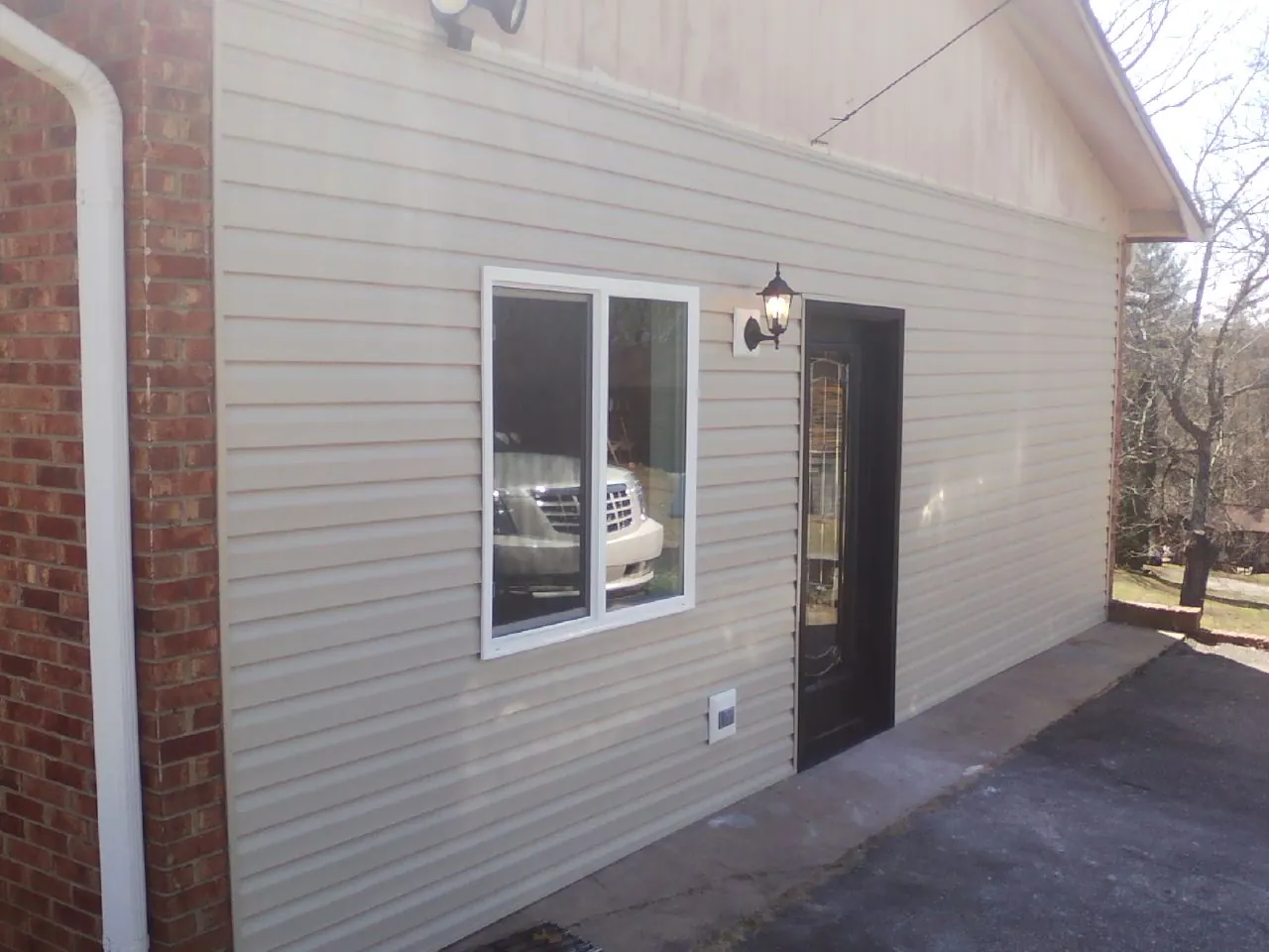 New vinyl siding and entry door on a room addition in Hinesville